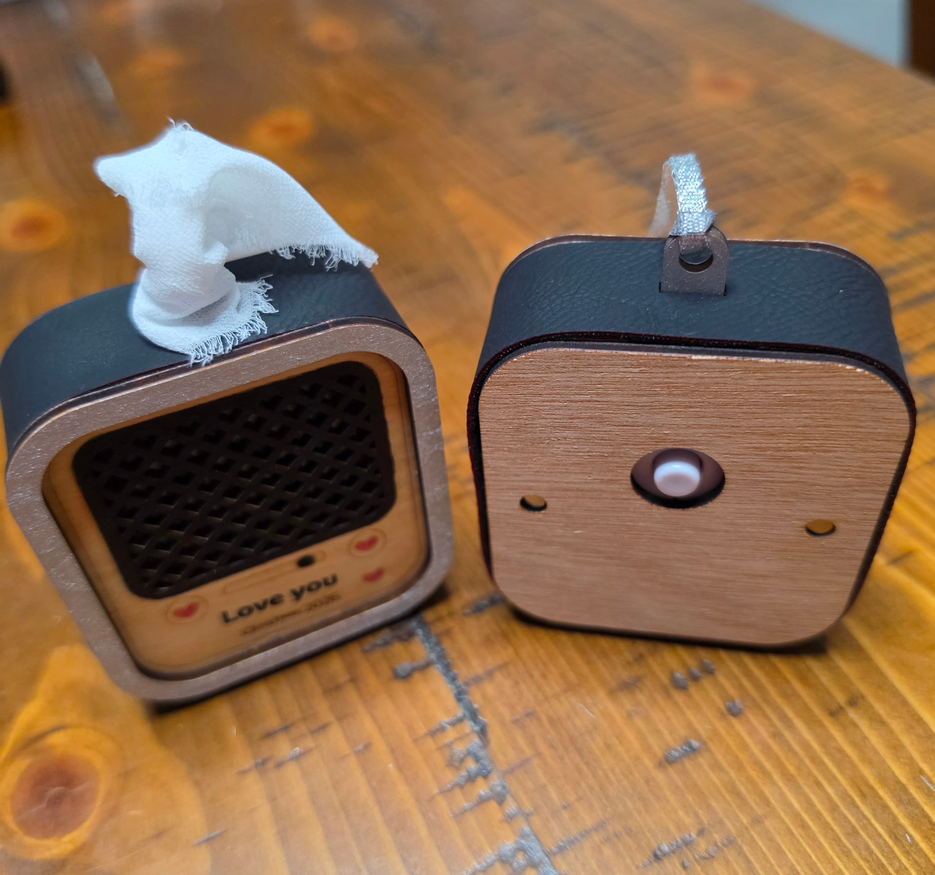 Front and back of the recordable ornament showing the wooden back panel and the record button