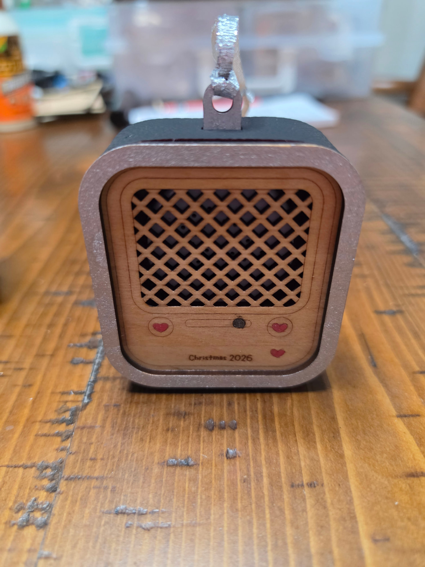 Front view of the retro radio ornament showing the laser-cut speaker grille, tuning dial, and hand-painted red hearts
