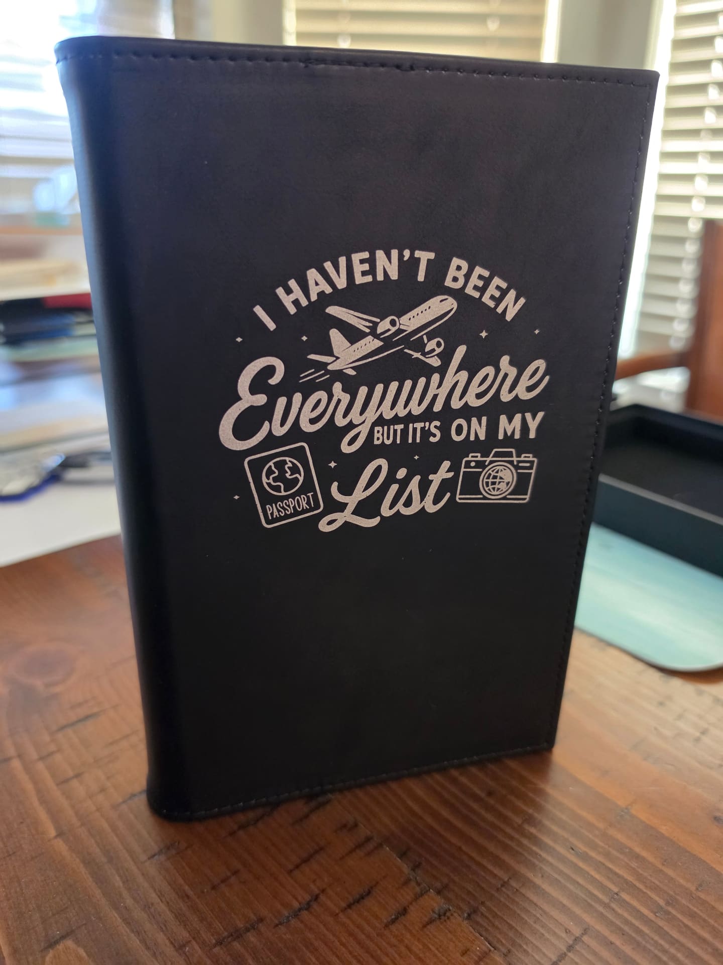 Black leather notebook engraved with 'I Haven't Been Everywhere But It's On My List'