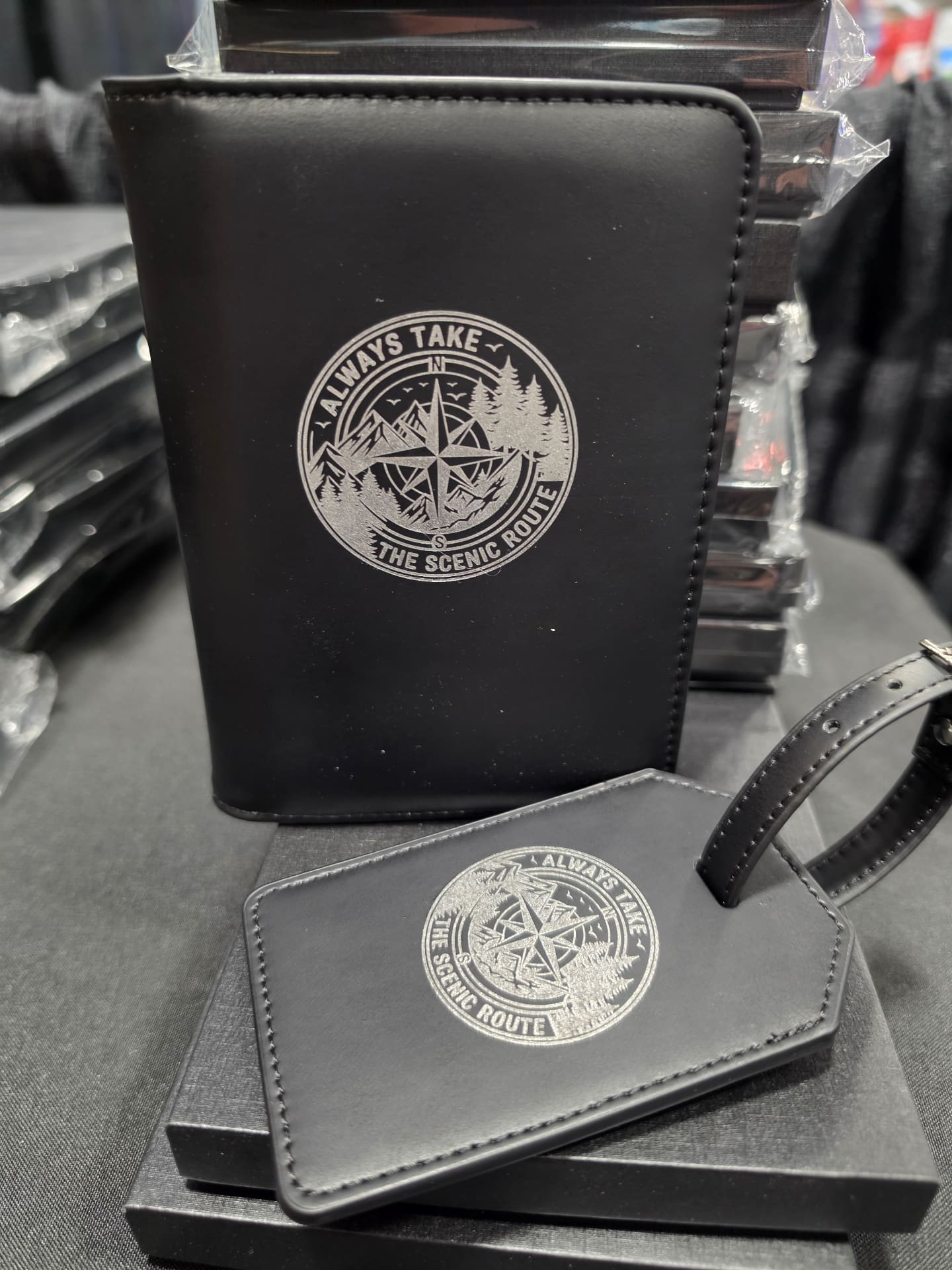 Engraved leather passport cover and luggage tag with 'Always Take The Scenic Route' compass design